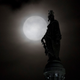 The moon behind the Statue of Freedom in Washington, DC.
